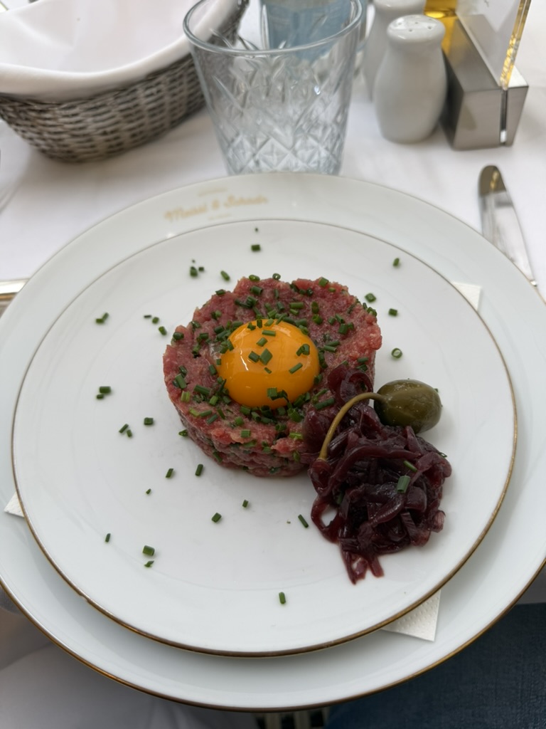 Beef tartare with egg yolk plated at a Parisian bistro