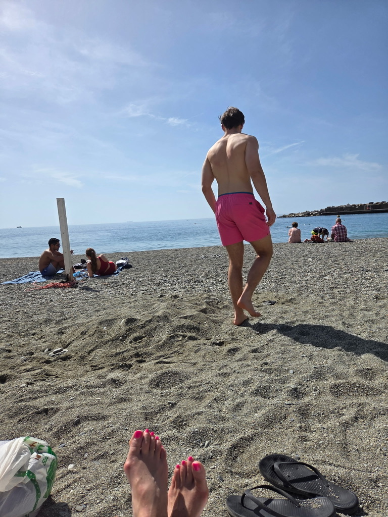 Hunter walking a Ligurian beach in Italy