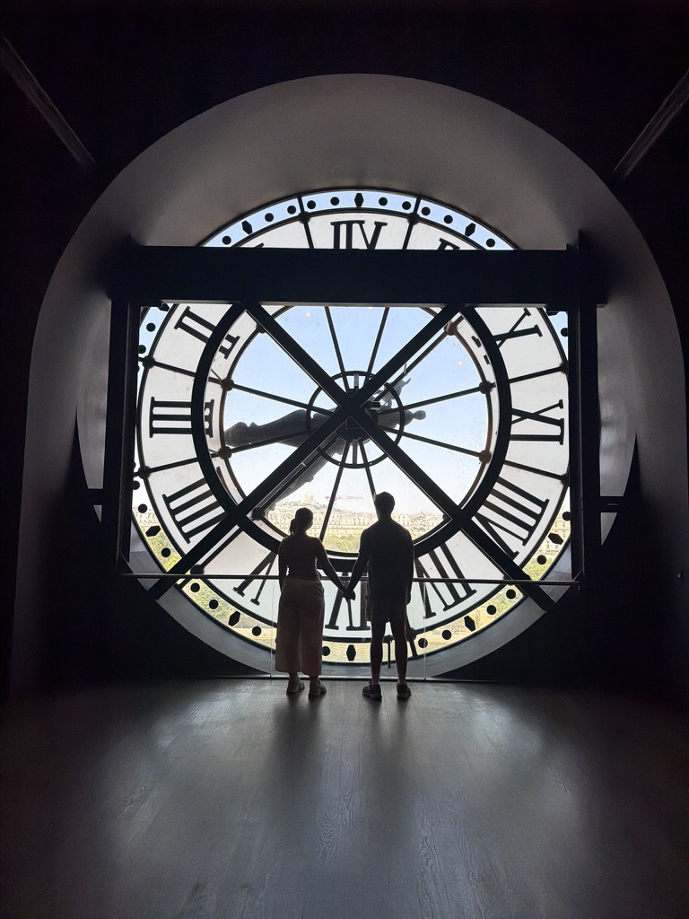 Hunter silhouetted inside the Musée d'Orsay clock in Paris